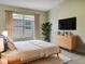 Comfortable bedroom with a large window, stylish dresser, and modern decor creating a peaceful retreat at 523 Glenn Cross Dr, Ruskin, FL 33570