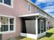 Exterior view featuring a screened-in patio with direct access to the yard at 523 Glenn Cross Dr, Ruskin, FL 33570