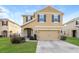 Inviting two-story home showcasing manicured lawn, stone accents, and a two-car garage at 2303 Ashberry Ridge Dr, Plant City, FL 33563