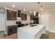 Elegant kitchen featuring a spacious island, stainless steel appliances, and contemporary lighting at 2303 Ashberry Ridge Dr, Plant City, FL 33563