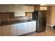 Kitchen featuring updated stainless steel appliances, stone countertops, and white cabinets at 721 Hancock Ave, Sarasota, FL 34232