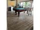 Open screened in porch features weathered wooden planks and a green pool table at 721 Hancock Ave, Sarasota, FL 34232