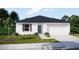 Well maintained single story home with white exterior and a nicely manicured lawn at 1317 Arrow St, Port Charlotte, FL 33952