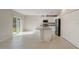 Bright and airy kitchen with island, stainless steel appliances, and tile flooring at 1317 Arrow St, Port Charlotte, FL 33952