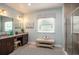 Bathroom featuring double vanity, decorative art and a glass-enclosed tiled shower at 22500 Provance Ave, Port Charlotte, FL 33954