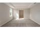 Bedroom featuring a tray ceiling, carpet flooring, and ample natural light at 22500 Provance Ave, Port Charlotte, FL 33954