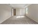 Large bedroom with a tray ceiling, carpet flooring and two entryways at 22500 Provance Ave, Port Charlotte, FL 33954