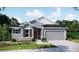 Well-maintained single-Gathering home featuring a manicured lawn and a two-car garage at 22500 Provance Ave, Port Charlotte, FL 33954