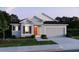 Charming single-story home featuring a well-manicured lawn and a two-car garage at 22500 Provance Ave, Port Charlotte, FL 33954