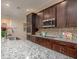 Close-up of the kitchen featuring granite countertops, stainless steel appliances, and stylish cabinetry at 22500 Provance Ave, Port Charlotte, FL 33954