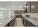 Modern kitchen featuring stainless steel appliances, granite countertops, and dark cabinetry at 22500 Provance Ave, Port Charlotte, FL 33954