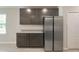 Kitchen with stainless steel refrigerator, granite countertops, and dark cabinets at 22500 Provance Ave, Port Charlotte, FL 33954