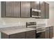 Modern kitchen features stainless steel appliances, granite countertops, and dark cabinetry at 22500 Provance Ave, Port Charlotte, FL 33954