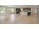 Open-concept kitchen with a large island, stainless steel appliances, and a dining area at 22500 Provance Ave, Port Charlotte, FL 33954
