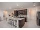Modern kitchen island with a granite countertop, stainless steel appliances, and seating for four at 22500 Provance Ave, Port Charlotte, FL 33954