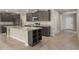Modern kitchen featuring granite countertops, stainless steel appliances, and a large center island at 22500 Provance Ave, Port Charlotte, FL 33954