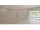 Open living room with tile floors, recessed lighting, and view of the backyard at 22500 Provance Ave, Port Charlotte, FL 33954
