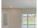 Bright living room featuring a sliding glass door and a modern light fixture at 22500 Provance Ave, Port Charlotte, FL 33954