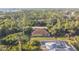 Aerial view of a single-Gathering home nestled within lush trees and close to a pool at 6098 San Salvador Rd, North Port, FL 34291