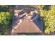 Detailed aerial view of a home roof, showcasing unique architectural design among trees at 6098 San Salvador Rd, North Port, FL 34291