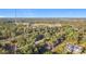 Aerial view of a single-Gathering home nestled within lush trees and close to a nearby structure at 6098 San Salvador Rd, North Port, FL 34291