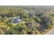 Aerial view of a single-Gathering home nestled within lush trees and close to another house at 6098 San Salvador Rd, North Port, FL 34291