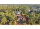 Aerial view of a boarded up house surrounded by trees at 6098 San Salvador Rd, North Port, FL 34291