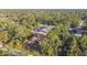 Aerial view of a single-Gathering home nestled within lush trees and close to a pool at 6098 San Salvador Rd, North Port, FL 34291