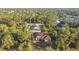 Aerial view of a single-Gathering home nestled within lush trees and close to a pool at 6098 San Salvador Rd, North Port, FL 34291
