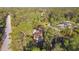 Aerial view of a single-Gathering home nestled within lush trees and close to another house at 6098 San Salvador Rd, North Port, FL 34291