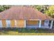 Close up of the rear of the boarded-up building, showing cinder block walls and overhanging roof at 6098 San Salvador Rd, North Port, FL 34291