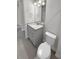 Bathroom with a white countertop vanity, mirror and toilet at 9793 Rally Spring Loop, Wesley Chapel, FL 33545
