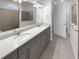 Modern bathroom with double vanity, undermount sinks, and walk-in shower at 9793 Rally Spring Loop, Wesley Chapel, FL 33545