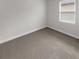 Comfortable bedroom with a window and carpet floors at 9793 Rally Spring Loop, Wesley Chapel, FL 33545