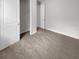 Bedroom with carpet floors, closet, and door to a hallway at 9793 Rally Spring Loop, Wesley Chapel, FL 33545