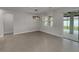 Dining room featuring stylish lighting, tile floor, and sliding glass door to the patio at 9793 Rally Spring Loop, Wesley Chapel, FL 33545