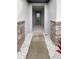 Covered entryway with stone accents and a decorative front door at 9793 Rally Spring Loop, Wesley Chapel, FL 33545