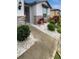 Well landscaped front yard with a stone walkway and lush greenery at 9793 Rally Spring Loop, Wesley Chapel, FL 33545