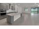 Modern kitchen with stainless steel appliances, gray cabinets, island and tile floors at 9793 Rally Spring Loop, Wesley Chapel, FL 33545