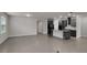 Open-concept living room and kitchen with large tile flooring and abundant natural light at 9793 Rally Spring Loop, Wesley Chapel, FL 33545