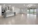 Open concept with tile flooring connects the kitchen, dining, and living spaces at 9793 Rally Spring Loop, Wesley Chapel, FL 33545