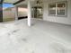 Large covered patio with concrete flooring, fan, and sliding glass door at 9793 Rally Spring Loop, Wesley Chapel, FL 33545