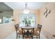 Cozy breakfast nook featuring a glass table and chairs with natural light from the sliding glass door at 2224 Mayfield Palms Ln # 321, Sun City Center, FL 33573