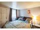 Inviting bedroom featuring soft lighting, patterned bedding, and a cozy atmosphere at 7961 50Th N Ave, St Petersburg, FL 33709