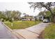 Quaint single-story home with well-maintained lawn, a driveway, and street view at 7961 50Th N Ave, St Petersburg, FL 33709