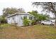 Charming single-story home with light blue siding, front yard landscaping, and a driveway at 7961 50Th N Ave, St Petersburg, FL 33709