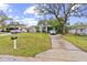 Charming single-story home with well-maintained lawn, a driveway, and street view at 7961 50Th N Ave, St Petersburg, FL 33709