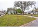 Modest single-story home with a well-maintained lawn, a driveway, and a leafy, mature tree at 7961 50Th N Ave, St Petersburg, FL 33709