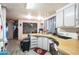 This cozy kitchen features wood countertops, white cabinets, and modern appliances at 7961 50Th N Ave, St Petersburg, FL 33709