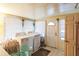 Functional laundry room with washer, dryer, and ample natural light through multiple windows at 7961 50Th N Ave, St Petersburg, FL 33709